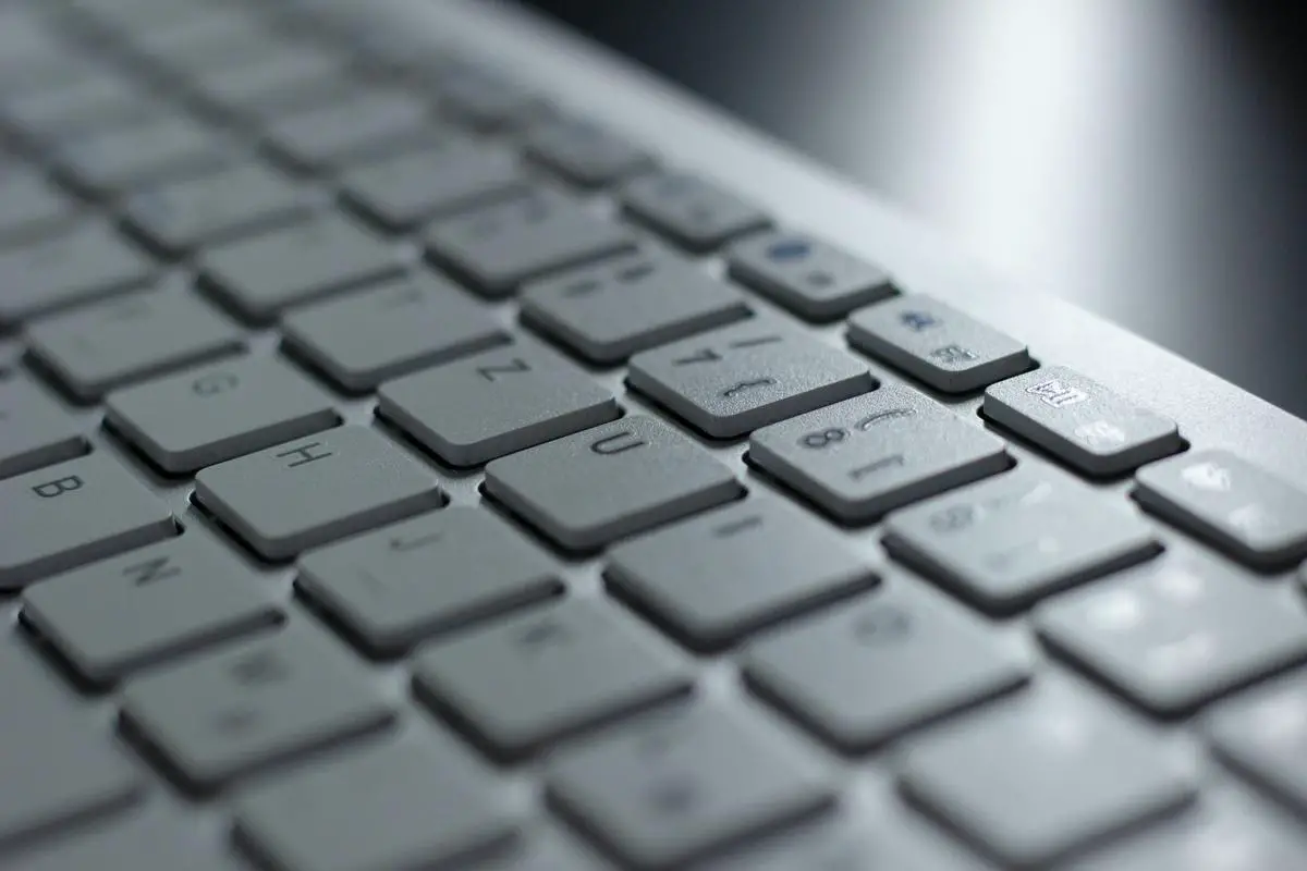 An image showing a person typing on a keyboard with the text 'Understanding ChatGPT' in the background, representing the topic of the text.