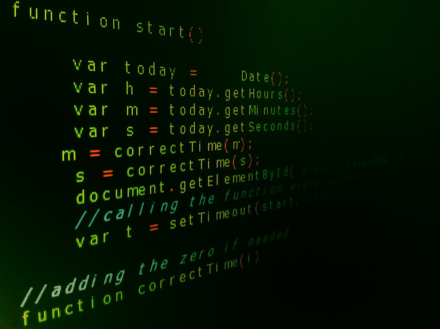 An image showing someone typing HTML code on a computer with a desk and other office supplies visible in the background.