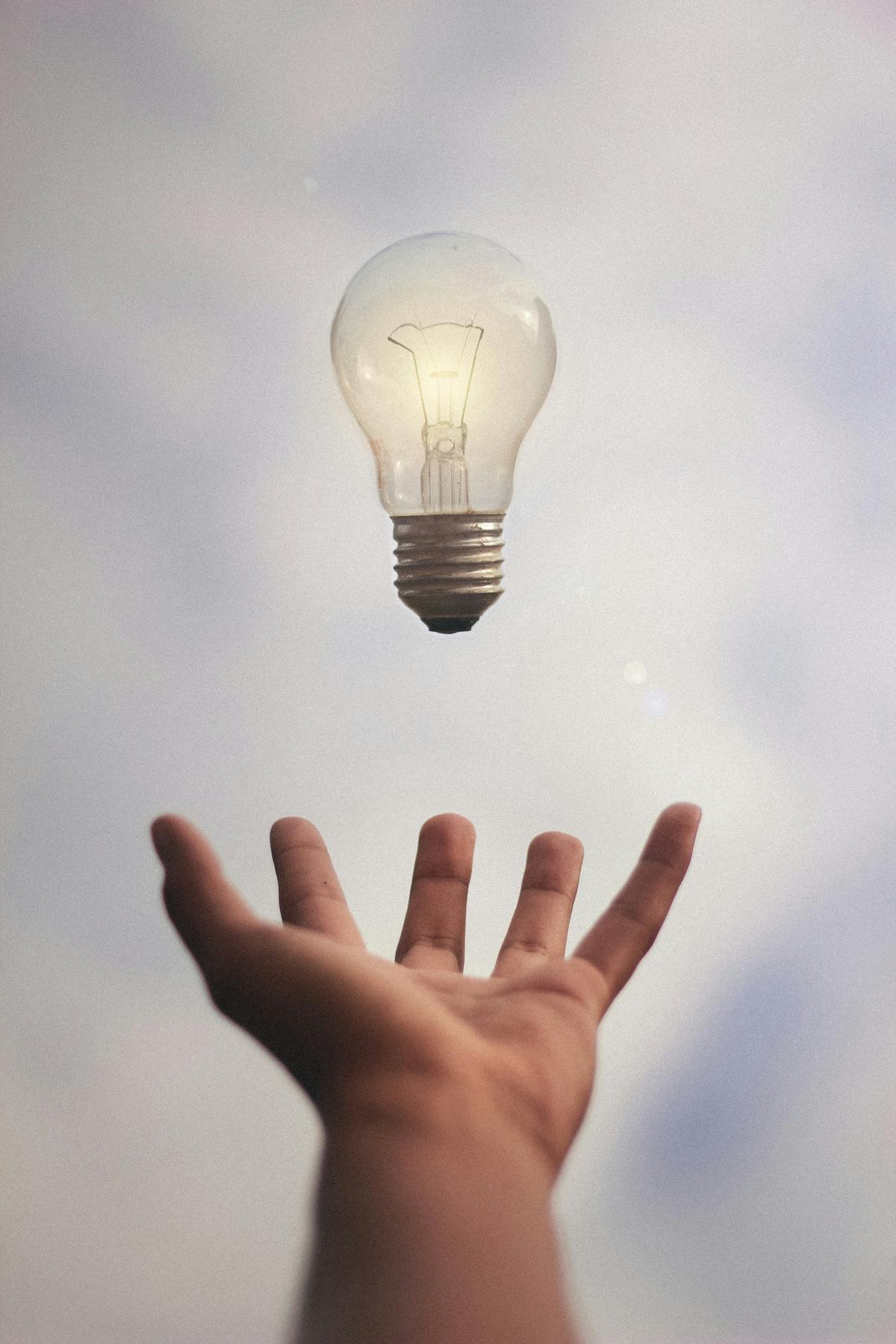 Illustration of a person brainstorming domain names with light bulb above their head