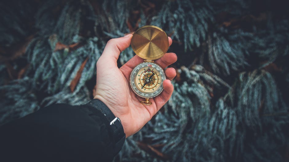 An image depicting a person holding a compass, symbolizing the need for guidance and direction in navigating the ethical considerations of using artificial intelligence for content creation.