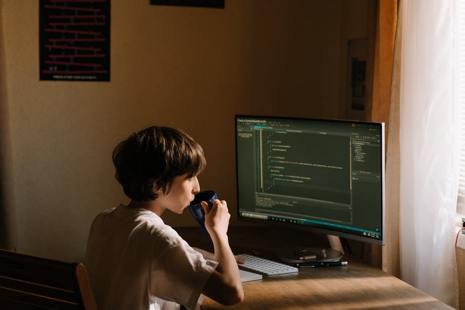 A developer critically reviewing GPT-generated code while consulting additional resources