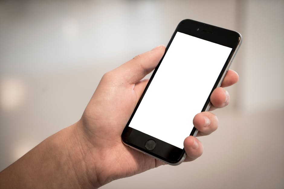 A person holding a smartphone with a website displayed on the screen, adapting seamlessly to the device's dimensions, representing the importance of mobile optimization and responsive design.