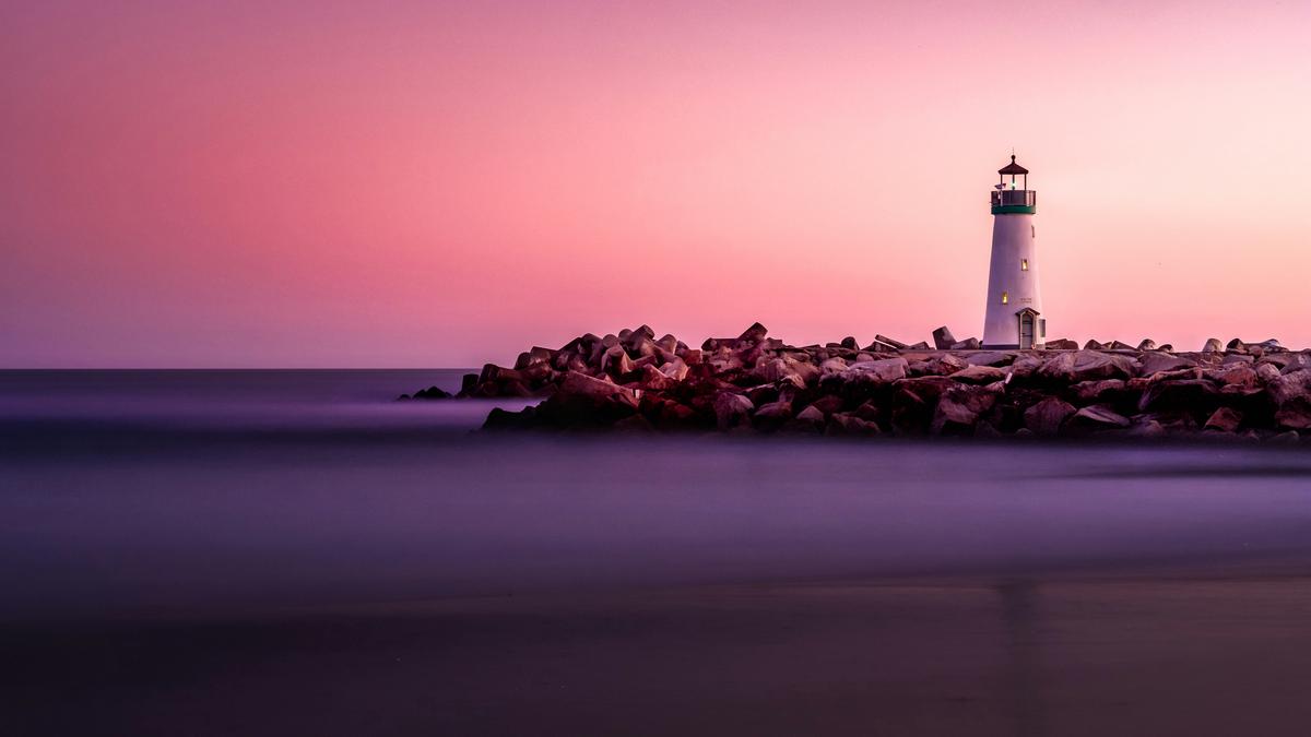 A lighthouse shining bright on a rocky shore, representing the importance of a strong technical SEO foundation for a website's visibility and success.