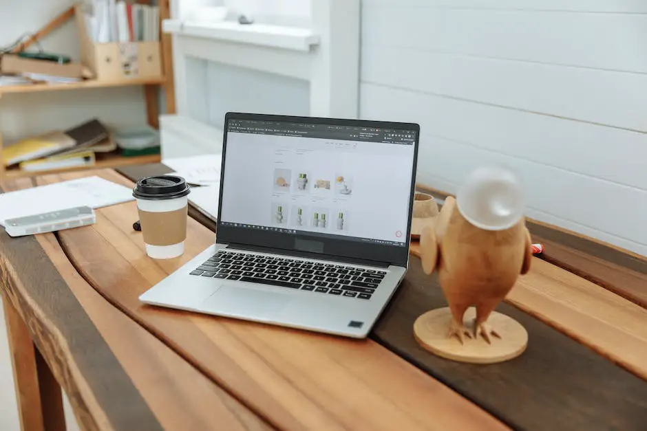 A person using a laptop to build a website on a desk with various tools and website elements around them.